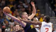 Nikola Jokic #15 of the Denver Nuggets is guarded by Terance Mann #14 and Kawhi Leonard #2 of the Los Angeles Clippers in the third quarter at Ball Arena on November 14, 2023 in Denver, Colorado. Matthew Stockman/Getty Images/AFP 