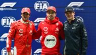 Ferrari's Monegasque driver Charles Leclerc (C) celebrates after finishing in pole position with second place Ferrari's Spanish driver Carlos Sainz Jr. (L) and third place Red Bull Racing's Dutch driver Max Verstappen (R) in Las Vegas, Nevada. (Photo by Angela Weiss / AFP)