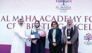 Ta’allum Group officials honouring  students who achieved top grades in external exams.