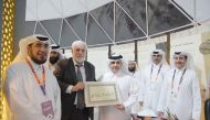 Minister of Municipality H E Dr. Abdullah bin Abdulaziz bin Turki Al Subaie is presented a plaque bearing his name by a calligrapher during the opening of the pavilion of the Ministry of Awqaf and Islamic Affairs at the Expo 2023 Doha yesterday. 