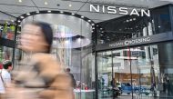 A pedestrian walks past the Nissan Crossing showroom in the Ginza area of central Tokyo on November 24, 2023. Photo by Richard A. Brooks / AFP