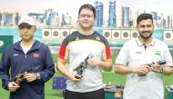 Winner, Germany's Peter Florian (centre), silver medallist Li Yuehong of China, and bronze medallist Anish Bhanwala of India pose for a photo after the Men's 25 meter rapid-fire pistol final. 