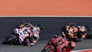 Ducati Italian rider Francesco Bagnaia drives ahead of Ducati Spanish rider Jorge Martin, KTM South African rider Brad Binder and KTM Australian rider Jack Miller during the MotoGP Valencia Grand Prix at the Ricardo Tormo racetrack in Cheste, on November 26, 2023. (Photo by JOSE JORDAN / AFP)
