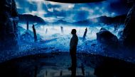 A man looks at a digital display at an exhibition by the Andrey Melnichenko Foundation during the COP28 United Nations climate summit in Dubai on December 1, 2023. (Photo by Ludovic Marin / AFP)
 