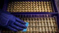 (Files) A worker polishes gold bullion bars at the ABC Refinery in Sydney on August 5, 2020. (Photo by David Gray / AFP)