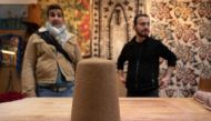 Yunus Girgic (R) and his customer Ashmi Benmehidi (L), a French musician stand in front of a traditional hat 