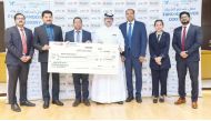 Regional Manager of Lulu Hypermarket Shanavas P presenting the donation cheque to Public Relations Officer of Qatar Cancer Society, Ammar Al Mashhadani.