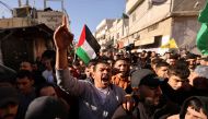 Mourners attend the funeral procession of two men killed in an Israeli army incursion in the al-Fawwar refugee camp, south of Hebron in the occupied West Bank, on December 26, 2023. Photo by HAZEM BADER / AFP