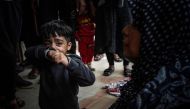 A child cries as people mourn loved ones killed during Israeli bombardment at Nasser Hospital in Khan Yunis on the southern Gaza Strip on December 27, 2023. Photo by AFP