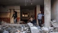 People inspect the damage following Israeli bombardment in Rafah on the southern Gaza Strip on December 29, 2023. (Photo by AFP)