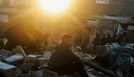 A boy sits on the rubble of a building destroyed by Israeli bombardment in Rafah refugee camp, south of the Gaza Strip, on January 1, 2024. Photo by AFP