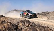 Nasser Racing’s Qatari driver Nasser Al Attiyah and his French co-driver Mathieu Baumel on their car during Stage 2 of the Dakar Rally 2024. AFP