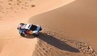 Nasser Racing’s Qatari driver Nasser Al Attiyah drives his car with French co-driver Mathieu Baumel through the dunes as they compete in Stage 5 of the Dakar Rally 2024. 