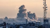 A picture taken from Rafah shows smoke billowing over Khan Yunis in the southern Gaza Strip during Israeli bombardment on January 14, 2024 (Photo by AFP)
 