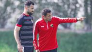 Jordan head coach Hussein Ammouta (right) with a player during a training session.