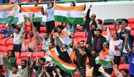 India fans cheer before the start of the Qatar 2023 AFC Asian Cup Group B football match between Australia and India at the Ahmad bin Ali Stadium in Al-Rayyan, west of Doha on January 13, 2024. (Photo by HECTOR RETAMAL / AFP)
