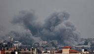 This picture taken from Rafah shows smoke billowing over Khan Yunis in the southern Gaza Strip on January 17, 2024. (Photo by AFP)