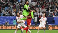 UAE's goalkeeper #17 Khalid Eisa jumps to save the ball during the Qatar 2023 AFC Asian Cup Group C football match between Palestine and United Arab Emirates at the Al Janoub Stadium on January 18, 2024. (Photo by Hector Retamal / AFP)