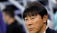 Indonesia's South Korean coach Shin Tae-Yong watches the Qatar 2023 AFC Asian Cup Group D football match between Indonesia and Iraq at the Ahmad bin Ali Stadium in Al-Rayyan, west of Doha on January 15, 2024. (Photo by KARIM JAAFAR / AFP)
