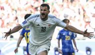 Iraq's forward #18 Aymen Hussein celebrates after scoring his team's first goal during the Qatar 2023 AFC Asian Cup Group D football match between Iraq and Japan at the Education City Stadium in Al-Rayyan on January 19, 2024. (Photo by Hector Retamal / AFP)