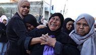 Relatives mourn during the funerals of some of the Palestinians, who were killed during a days-long Israeli raid, in a refugee camp in Tulkarm in the occupied West Bank on January 19, 2024 . (Photo by Zain Jaafar / AFP)