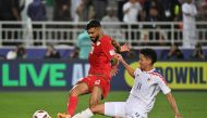 Thailand's midfielder #11 Bordin Phala vies for the ball against Oman's midfielder #20 Salaah al-Yahyaei during the Qatar 2023 AFC Asian Cup Group F football match between Oman and Thailand at the Abdullah bin Khalifa Stadium in Doha on January 21, 2024. (Photo by HECTOR RETAMAL / AFP)