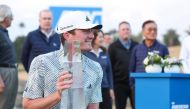 Nick Dunlap of the US poses for a photo with the trophy after winning The American Express at Pete Dye Stadium Course on January 21, 2024 in La Quinta, California. Sean M. Haffey/Getty Images/AFP 