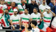 Iran’s forward Mehdi Taremi acknowledges supporters after win over  United Arab Emirates at Education City Stadium yesterday. AFP