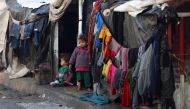 Children stand outside tents at a makeshift tent camp housing displaced Palestinians in Rafah near the border with Egypt in the southern Gaza Strip on January 23, 2024. Photo by AFP