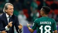 Saudi Arabia's Italian coach Roberto Mancini speaks with his midfielder #18 Abdulrahman Ghareeb during the Qatar 2023 AFC Asian Cup Group F football match between Kyrgyzstan and Saudi Arabia at the Ahmad Bin Ali Stadium in Al-Rayyan, west of Doha on January 21, 2024. (Photo by KARIM JAAFAR / AFP)