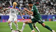 Saudi Arabia’s Faisal Al Ghamdi (right) fights for the ball with two Thailand players. AFP