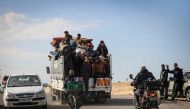 Palestinians ride a truck with some of their belongings as they flee Khan Yunis toward Rafah further south in the Gaza Strip, on January 25, 2024. (Photo by AFP)