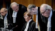 ICJ President Joan Donoghue (C) and ICJ judges arrive at the International Court of Justice (ICJ) prior to the verdict announcement in the genocide case against Israel, brought by South Africa, in The Hague on January 26, 2024. (Photo by Remko de Waal / ANP / AFP)