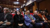 South Africa's Ambassador to Palestine Shaun Byneveldt (3L) attends with Palestinians a live projection of the International Court of Justice (ICJ) hearing of the case brought by his country against Israel, at the Ramallah municipality in the occupied West Bank on January 26, 2024. (Photo by Zain JAAFAR / AFP)
