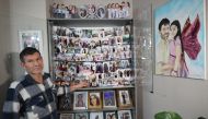 Mesut Hancer, stands infront of photographs of his 15-year-old-daughter Irmak, on February 6, 2023, during an interview in Ankara on January 11, 2024. (Photo by Adem Altan / AFP)