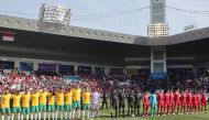 Indonesia's players (R) and Australia's players stand for their national anthems before the start of their match at Jassim bin Hamad Stadium in Doha on January 28, 2024. Photo by Giuseppe Cacace / AFP