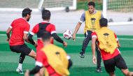 Coach Hussein Ammouta (second right) supervises Jordan's training session.