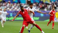 Iraq's forward #18 Aymen Hussein fights for the ball with Jordan's defender #05 Yazan al-Arab during the match between Iraq and Jordan at Khalifa International Stadium in Doha on January 29, 2024. (Photo by KARIM JAAFAR / AFP)
