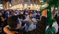 Saudi Arabia supporters gather on a street at the Souq Waqif in Doha on January 22, 2024, during the AFC Qatar 2023 Asian Cup. (Photo by Hector RETAMAL / AFP)
