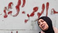 The mother of Muhammad Ayman Ghazawi and Basel Ayman Ghazawi, two of three Palestinian men killed by undercover Israeli agents mourns during their funeral in the occupied West Bank city on January 30, 2024. (Photo by Zain Jaafar / AFP)