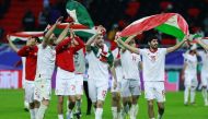 Tajikistan players celebrate their Round of 16 win.