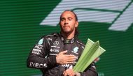 File: Mercedes' British driver Lewis Hamilton holds the trophy on the podium after winning Brazil's Formula One Sao Paulo Grand Prix at the Autodromo Jose Carlos Pace, or Interlagos racetrack, in Sao Paulo, on November 14, 2021. (Photo by Lars Baron / POOL / AFP)