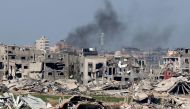 Smoke rising above destroyed buildings in the Gaza Strip yesterday. (AFP)