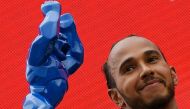 Second-placed Mercedes' British driver Lewis Hamilton celebrates with the trophy on the podium at the end of the French Formula One Grand Prix at the Circuit Paul-Ricard in Le Castellet, southern France, on June 20, 2021. Photo by NICOLAS TUCAT / POOL / AFP