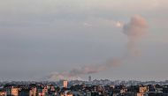 A picture taken from Rafah in the southern Gaza Strip shows smoke rising over buildings in Khan Yunis following Israeli bombardment on February 3, 2024. (Photo by Said Khatib / AFP)