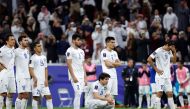 Uzbekistan’s players react after defeat against Qatar.