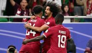 Jassem Gaber (left) celebrates with teammates Akram Afif and Almoez Ali after scoring Qatar’s first goal against Iran. AFP