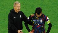 South Korea coach Jurgen Klinsmann consoles Son Heung-min after the loss. AFP