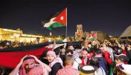 Jordan fans celebrate with national flags after their team reached the final.