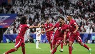 Jassem Gaber celebrates with teammates after scoring Qatar’s first goal against Iran. 